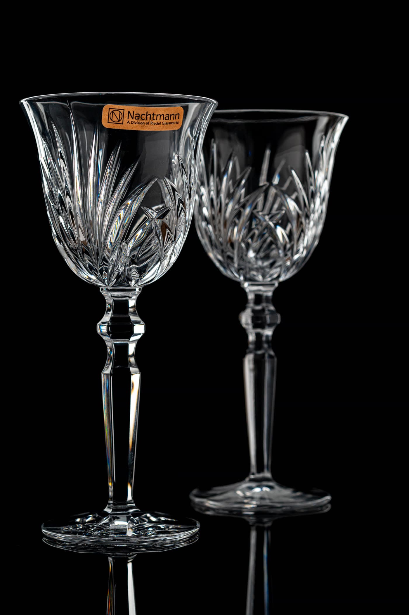 Vertical crystal glassware frame focused on clarity and controlled reflection.