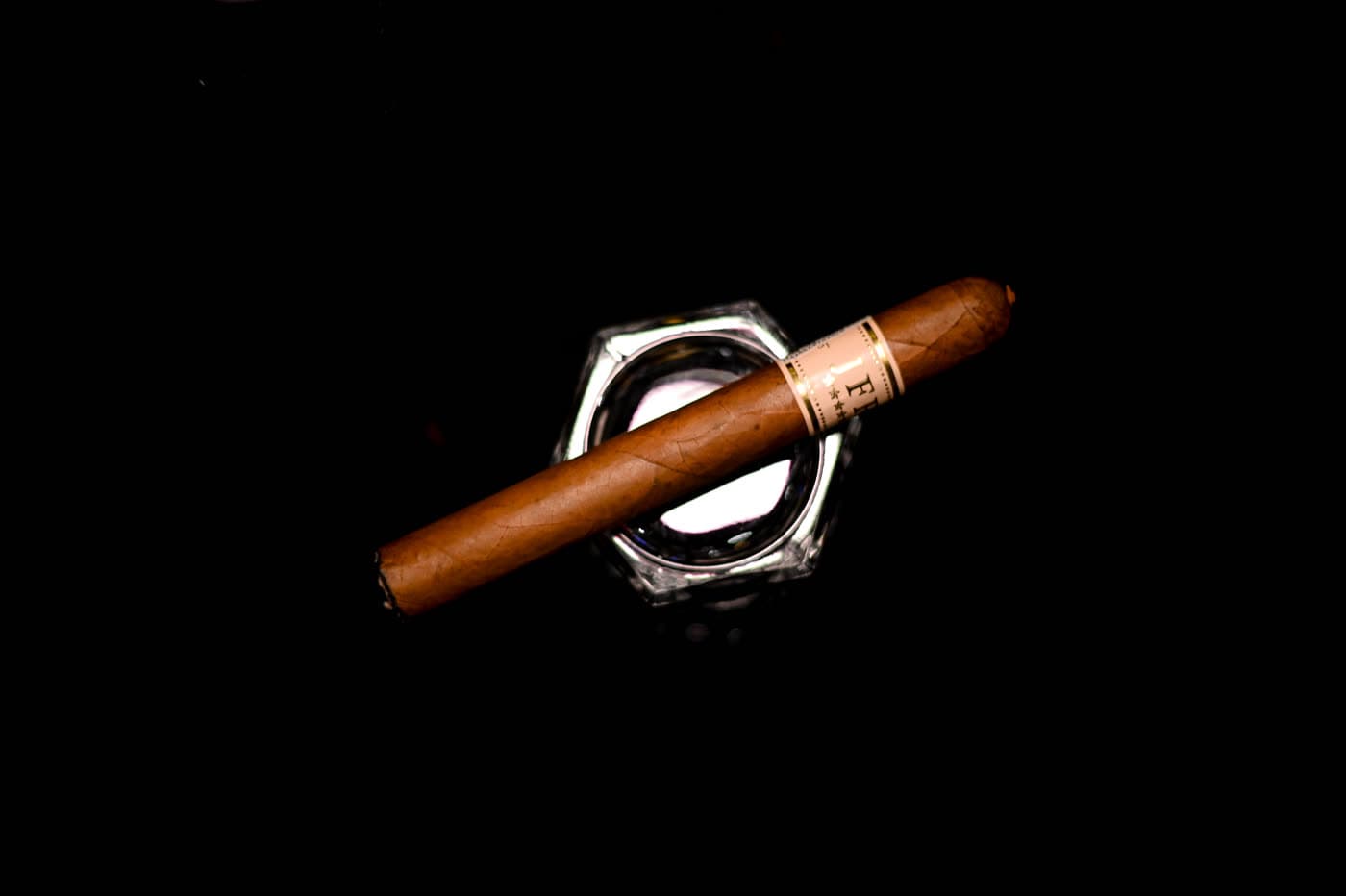 Wide cigar still life shaped by directional light and material detail.